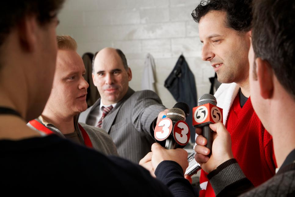 Hockey Player Giving Interview to Reporters