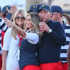 JERSEY CITY, NJ - OCTOBER 01:   Paulina Gtetzky takes a selfie with  Daniel Berger of the United States and his girlfriend Victoria Slater at the Presidents Cup on October 1, 2017, at Liberty National Golf Clubin Jersey City NJ.  (Photo by Rich Graessle/Icon Sportswire via Getty Images)