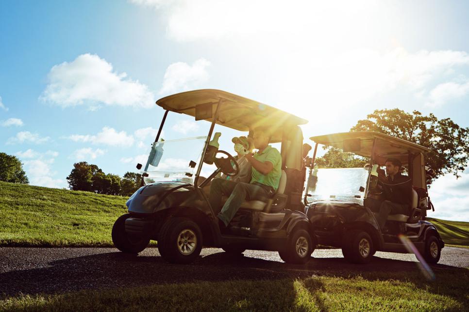 Shot of a group of friends riding in a golf cart on a golf course