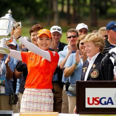 COLORADO SPRINGS, CO - JULY 11:  So Yeon Ryu of South Korea recieves the trophy from Martha Lang, Chairman of the USGA Women's Committee, after winning in a playoff against Hee Kyung Seo of South Korea during the final round of the U.S. Women's Open at the Broadmoor on July 11, 2011 in Colorado Springs, Colorado.  (Photo by Mike Ehrmann/Getty Images)