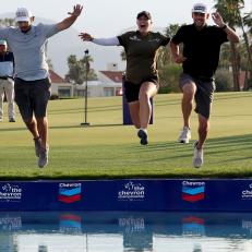 RANCHO MIRAGE, CALIFORNIA - APRIL 03: (Center) Jennifer Kupcho of the United States jumps into Poppie's Pond after winning The Chevron Championship at The Westin Mission Hills Golf Resort & Spa on April 03, 2022 in Rancho Mirage, California. (Photo by Harry How/Getty Images)