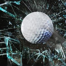 Fast golf ball through broken window.