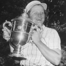 (Original Caption) Babe Didrikson Zaharias grins and hugs the cup she received after becoming the first three-time winner of the U.S. Women's Open Golf Championship with a 72-hole 291. With a card of 72-71-73-75, The Babe earned $2,000 in prize money and another open crown to wear with those she took in 1948 and 1950.
