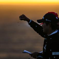 PEBBLE BEACH, CA - FEBRUARY 05:  S.H. Kim of South Korea is silhouetted as he drops grass to check the wind from the seventh tee during the final round of the AT&T Pebble Beach Pro-Am at Pebble Beach Golf Links on February 5, 2023 in Pebble Beach, California. (Photo by Keyur Khamar/PGA TOUR via Getty Images)