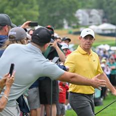 CROMWELL, CONNECTICUT - JUNE 24: Rory McIlroy of Northern Ireland high fives fans while walking onto the first tee box during the third round of the Travelers Championship at TPC River Highlands on June 24, 2023 in Cromwell, Connecticut. (Photo by Ben Jared/PGA TOUR via Getty Images)