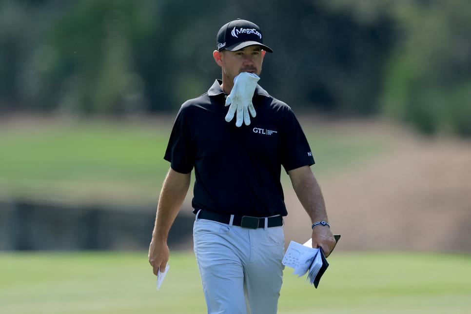 PONTE VEDRA BEACH, FLORIDA - MARCH 17: Brian Harman of The United States walks to his second shot on the 10th hole with his golf glove in his mouth during the final round of THE PLAYERS Championship at TPC Sawgrass on March 17, 2024 in Ponte Vedra Beach, Florida. (Photo by David Cannon/Getty Images)
