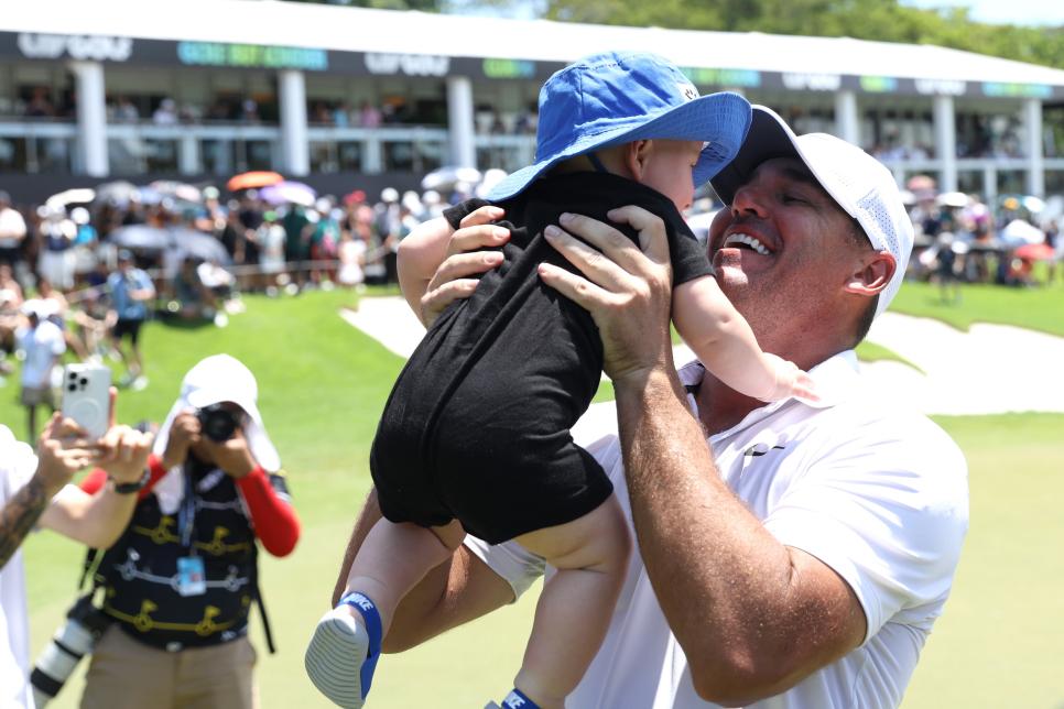 SINGAPORE, SINGAPORE - MAY 05: Brooks Koepka of Smash GC celebrates his victory with his son on the eighteenth green during day three of the LIV Golf Invitational - Singapore at Sentosa Golf Club on May 05, 2024 in Singapore, Singapore. (Photo by Lionel Ng/Getty Images)