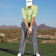 Picture two points, one midway between the shoulders and one midway between the hips. These are the swing centers, and they should be stacked, setting the spine vertical. The grip is neutral, the weight 60-40 on the front foot.



 Here Aaron is hitting a 5-iron, so his ball position is just ahead of the middle of his stance, directly below the centers. This over-the-ball posture pre-sets a rotary swing with no shift to the back foot.