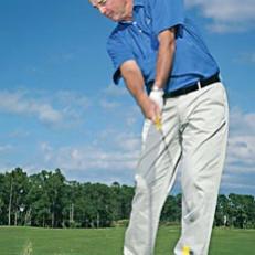 To get down in the 80s, focus on making solid contact with your irons. Accomplish that by making a downward strike, with your weight moving to your front foot at impact (*left*). You want the bottom of your swing arc in front of the ball.



 One way to check the bottom of your swing is to hit irons off a tee and assess your divots (*below, left*). If your weight is forward, your body is turning open and your arm triangle is intact, the divot will come after impact.