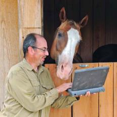 Jaime Diaz checks over a story with Jet on his horse farm outside Pinehurst, N.C.