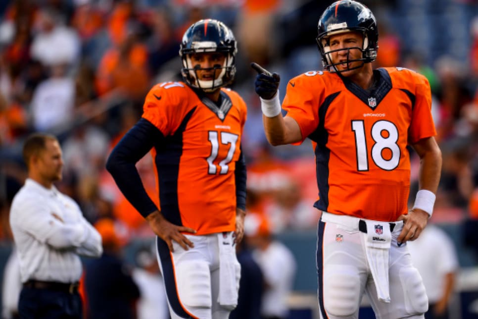 Denver Broncos quarterback Peyton Manning tries to put his jersey back on  his shoulder pads during an NFL football game between the Denver Broncos  and the Kansas City Chiefs, Sunday, Nov. 15