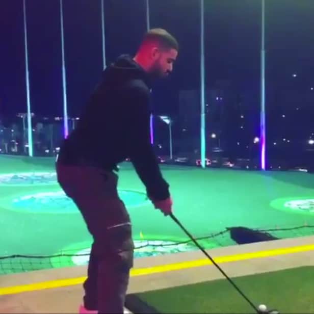 Watch Drake hit balls at TopGolf while listening to his own music