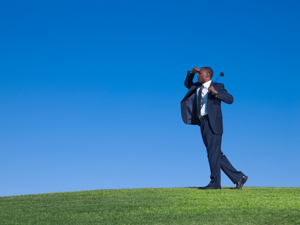 African businessman playing golf