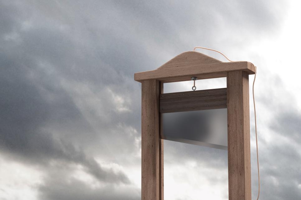 Traditional Guillotine against a stormy sky