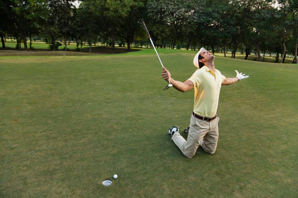 Young man playing golf, kneeling and gesturing