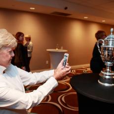 Pat Bradley takes a picture of the new U.S. Senior Women\'s Open trophy during the 2018 USGA Annual Meeting at Fontainebleau Hotel in Miami Beach, FL on Friday, Feb. 2, 2018.  (Copyright USGA/John Mummert)