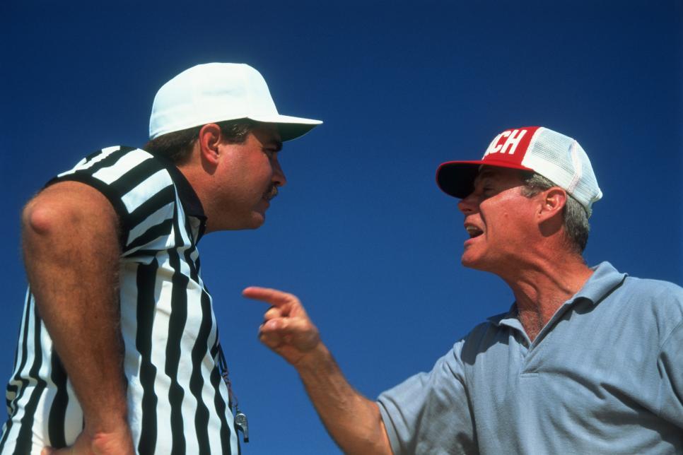 Referee and coach arguing, close-up