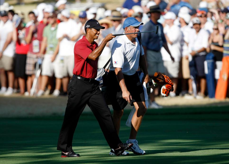 Tiger Woods, along with caddy Steve Williams, points to the