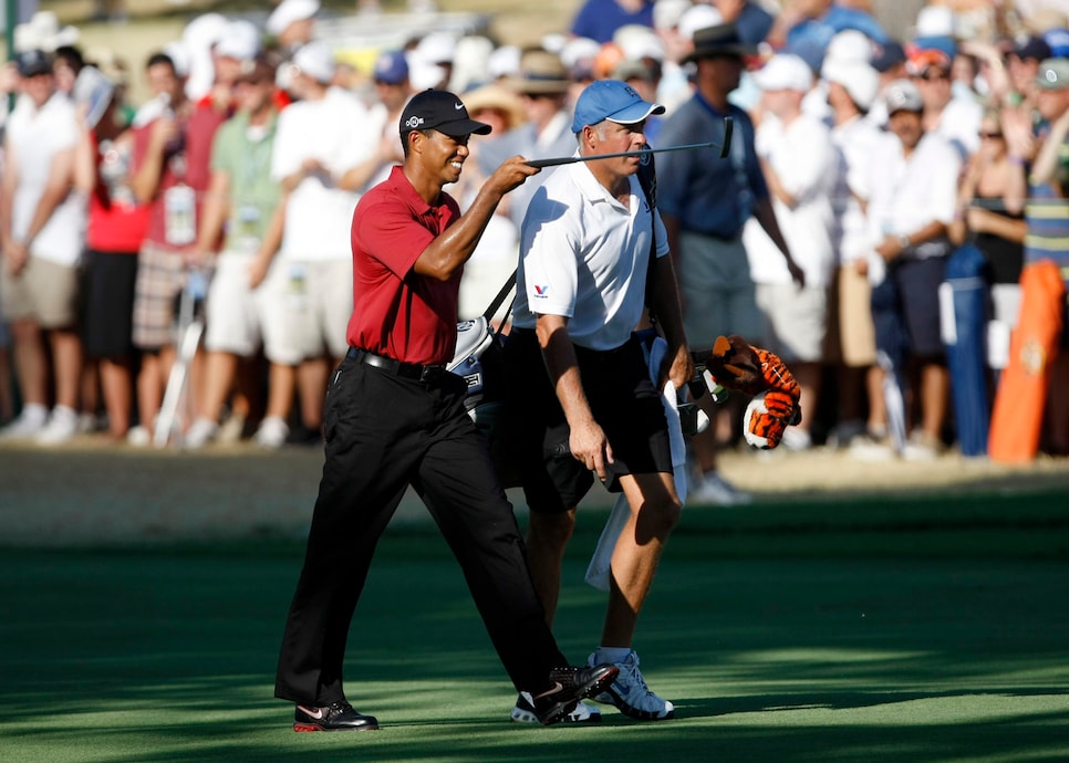 Tiger Woods, along with caddy Steve Williams, points to the