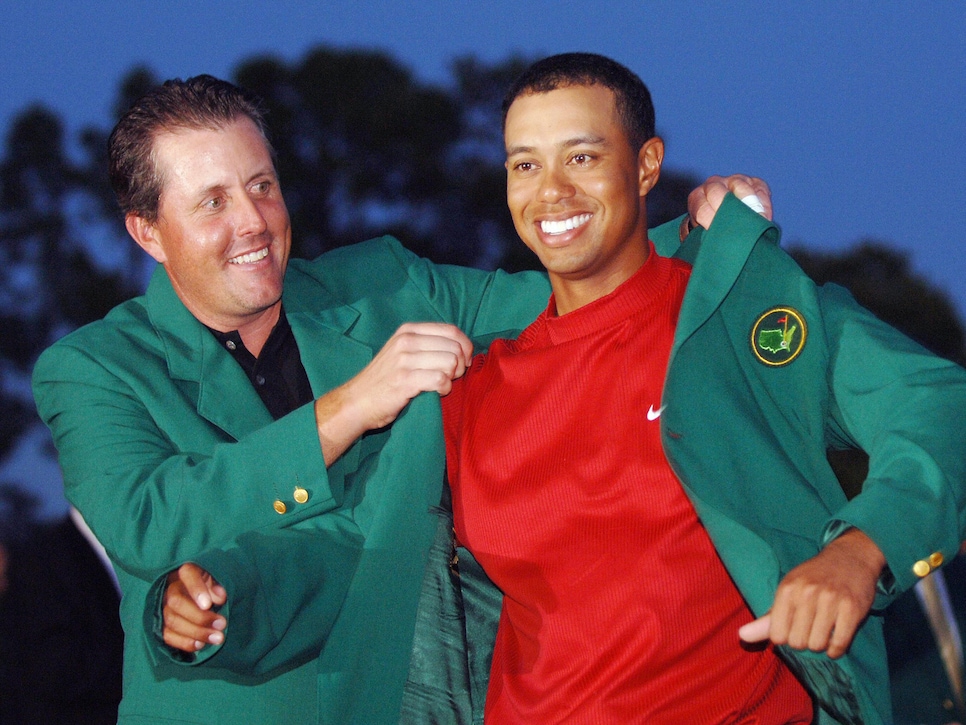 AUGUSTA, UNITED STATES:  US golfer Tiger Woods (R) is awarded his green jacket by 2004 champion Phil Mickelson of the US at the 2005 Masters Golf Tournament Championship 10 April 2005 at the Augusta National Golf Club in Augusta, Ga. Woods claimed his 4th Masters title by defeating fellow American Chris DiMarco in a one-hole playoff.     AFP PHOTO/Roberto SCHMIDT  (Photo credit should read ROBERTO SCHMIDT/AFP/Getty Images)