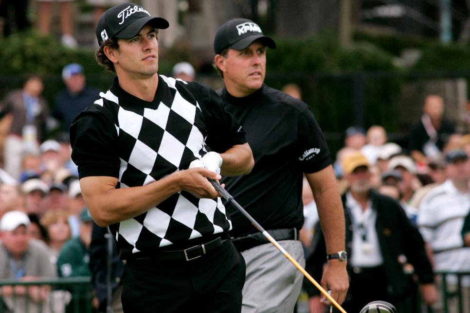 Golfers Adam Scott, left, and Phil Mickelson follow Scott's