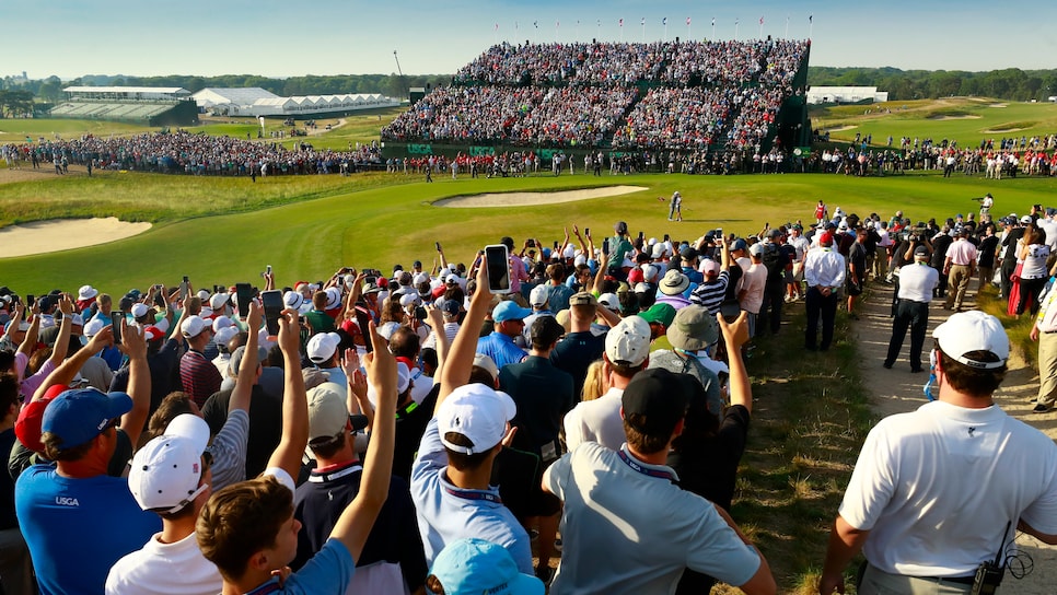 Fans watch Brooks Koepka celebrate his second US Open Championship victory with his caddie during the final round of the 2018 U.S. Open at Shinnecock Hills Golf Club in Southampton, N.Y. on Sunday, June 17, 2018.  (Copyright USGA/Jason Miczek)