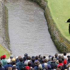 Carnoustie, UNITED KINGDOM: Irish Padraig Harrington chips the ball across a burn after taking a drop for playing into the water on the 18th hole during the final round of the 136th British Open Golf Championship at Carnoustie, Scotland, 22 July 2007. AFP PHOTO/POOL-Phil NOBLE (Photo credit should read -/AFP/Getty Images)