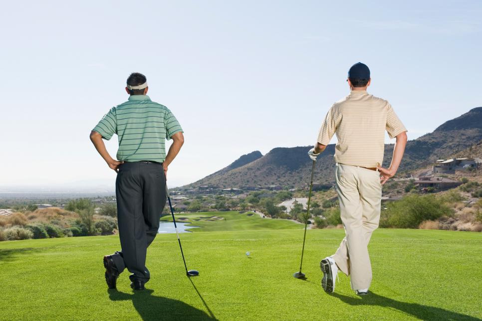 Hispanic men playing golf