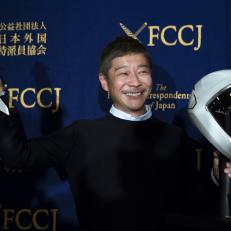 Yusaku Maezawa, chief executive officer of Zozo Inc., poses with a model of the SpaceX BFR rocket and the spacesuit\'s helmet during a news conference at the Foreign Correspondents\' Club of Japan in Tokyo, Japan, on Tuesday, Oct. 9, 2018. Japanese billionaire Maezawa said working less, not more, is his secret to building a $8.4 billion company, becoming a major force in the art world and landing a ticket on Elon Musk’s rocket to the moon. The founder of Japan’s second-largest online shopping site Zozo was introduced last month as the first passenger on a flight to the moon scheduled for 2023, on a rocket built by Space Explorations Technologies Corp. Photographer: Tohomohiro Ohsumi/Bloomberg