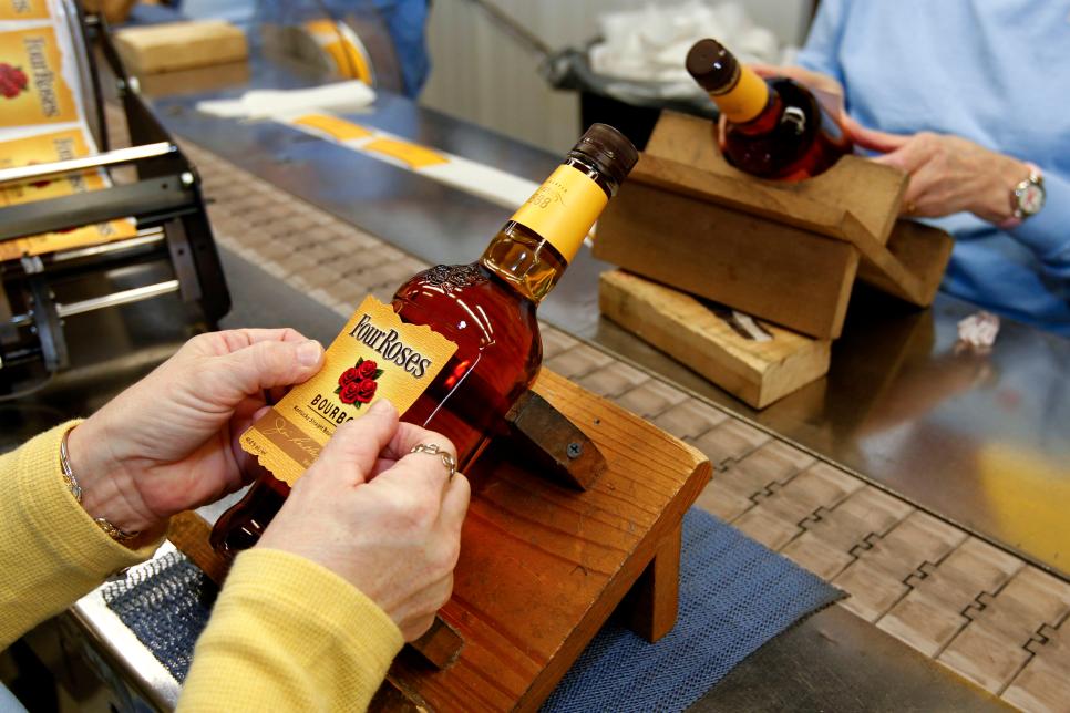 Four Roses Distillery LLC employees hand-label bottles of Fo