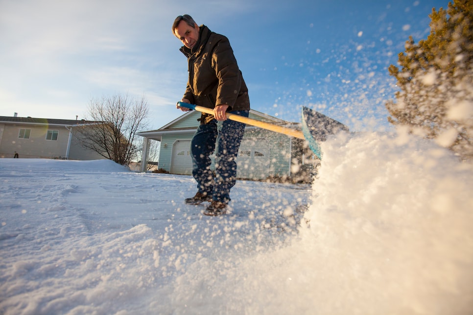 A man shovels snow off his driveway in northern Alberta.