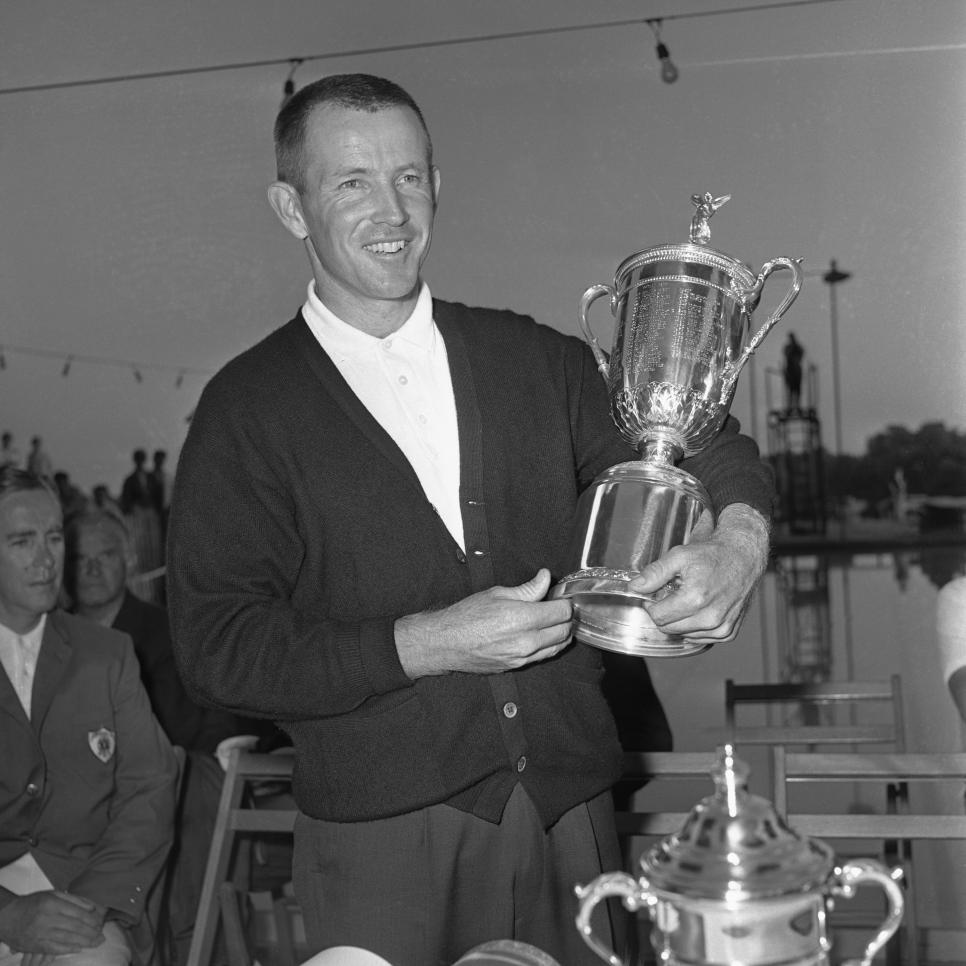 Golfer Gene Littler Holding Trophy Cup