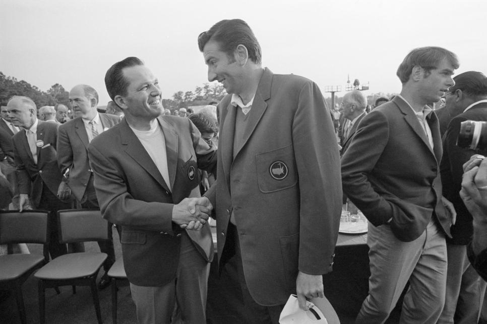 (Original Caption) 4/13/1969-Augusta, GA- Tall George Archer (R) accepts congratulations from defending champion Bob Goalby after donning his new green coat, symbol of Masters champions. Archer scored his first major title win by a one-stroke margin.