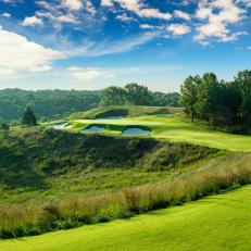 the green of the The par 3 8th at Ozarks National site precariously on a ledge.  The early morning light on the beautiful par three makes it very inviting.  Coore and Crenshaw have created another masterpiece at Big Cedar Lodge in the Missouri OZARKS.