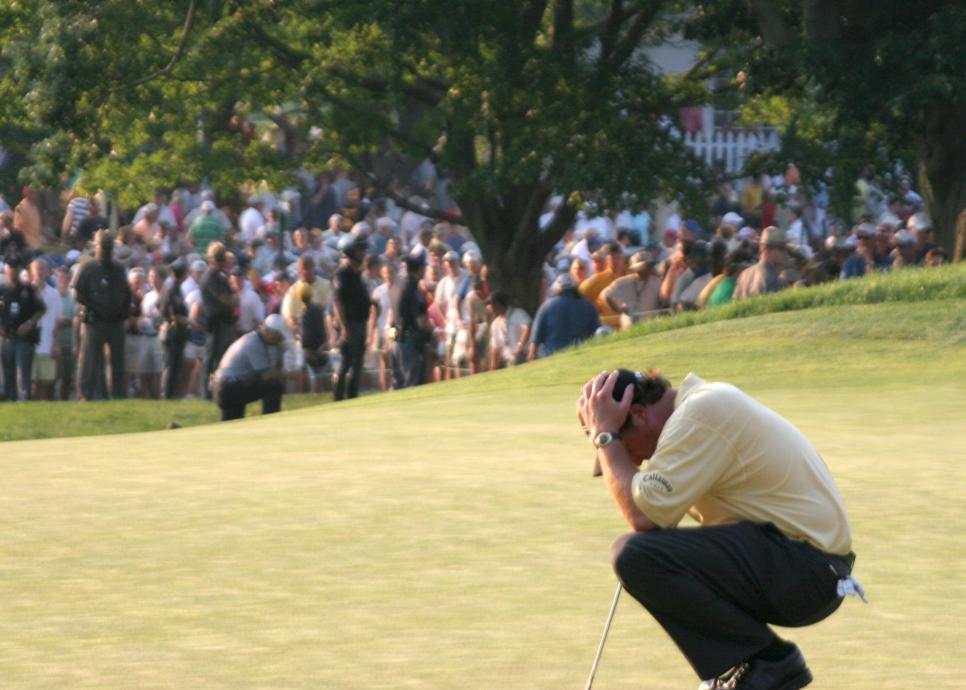 Golfer Phil Mickelson holds his head in his hands June 18, 2