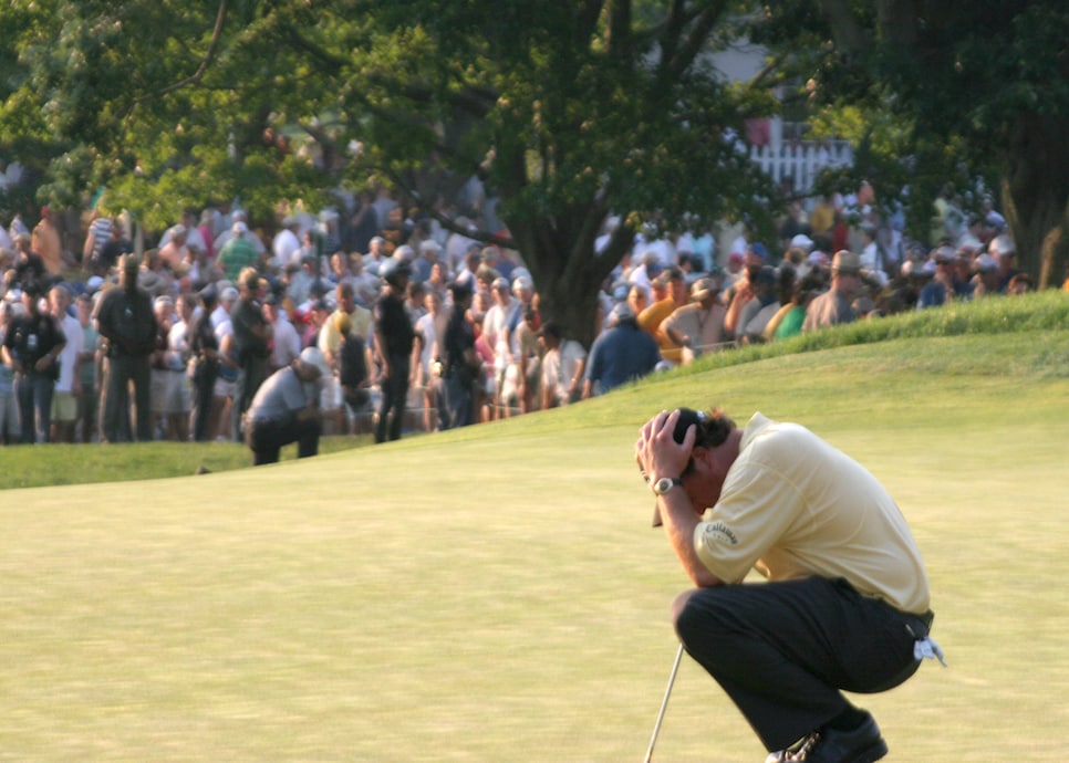 Golfer Phil Mickelson holds his head in his hands June 18, 2