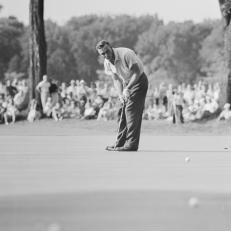 (Original Caption) Arnold Palmer making his putt on the 18th green to within a few inches of the cup and close enough for a cinch par four so that he and Sweeny conceded each others putts to halve the hole and give Palmer a one up victory in the 54th National Amateur.