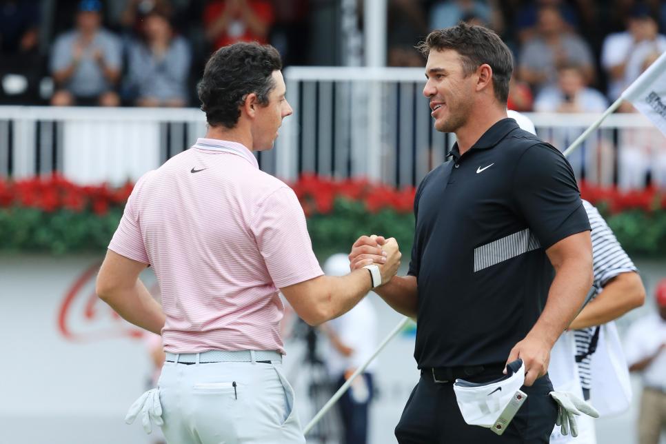 ATLANTA, GEORGIA - AUGUST 25: Brooks Koepka of the United States congratulates Rory McIlroy of Northern Ireland on the 18th green after McIlroy won the FedEx Cup and Tour Championship during the final round of the TOUR Championship at East Lake Golf Club on August 25, 2019 in Atlanta, Georgia. (Photo by Streeter Lecka/Getty Images)
