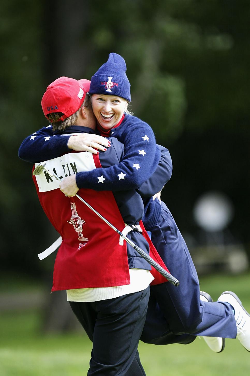 Emilee Klein of the USA jumps into her caddy's arms
