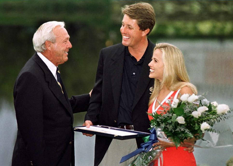 Golfer Arnold Palmer (L) congratulates Phil Mickel