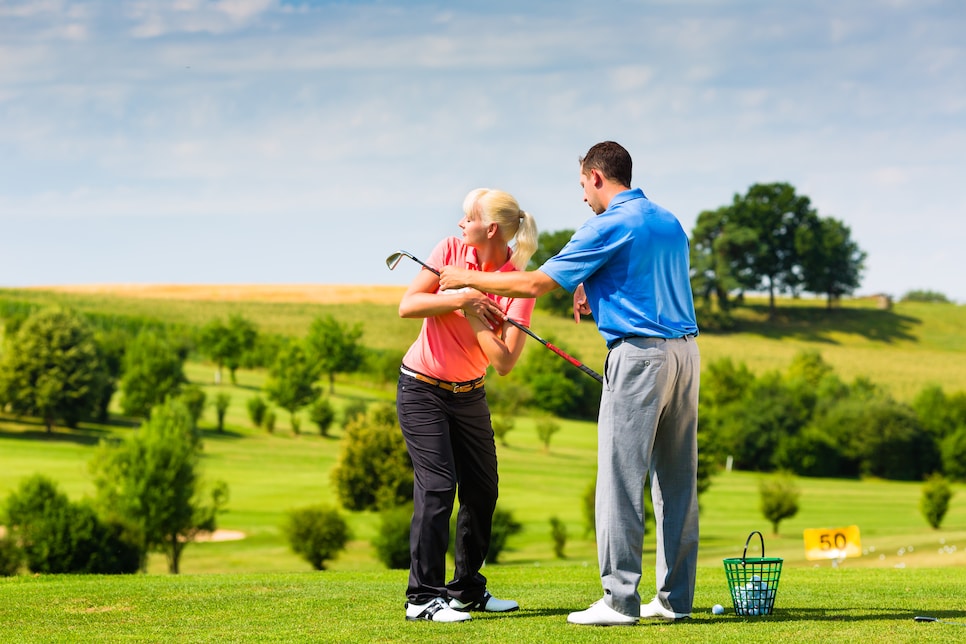 Young female golf player on course