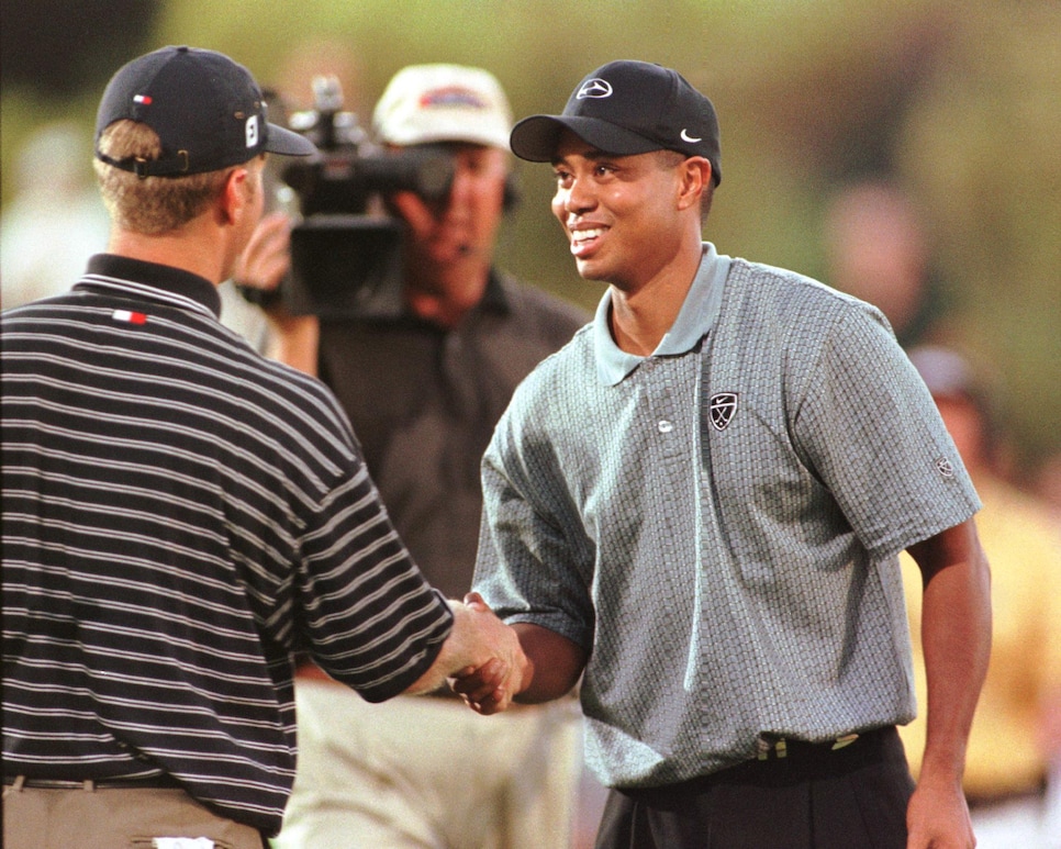 US golfer Tiger Woods (R) shakes hands with opponent David Duvall after winning the one-on-one match play on the 17th hole at the "Showdown at Sherwood" 02 August 1999 at Sherwood Country Club in Thousand Oaks, Ca. The two top golfers in the world  played for a 1.5 million USD prize.  AFP PHOTO  Vince BUCCI (Photo by VINCE BUCCI / AFP)        (Photo credit should read VINCE BUCCI/AFP/Getty Images)