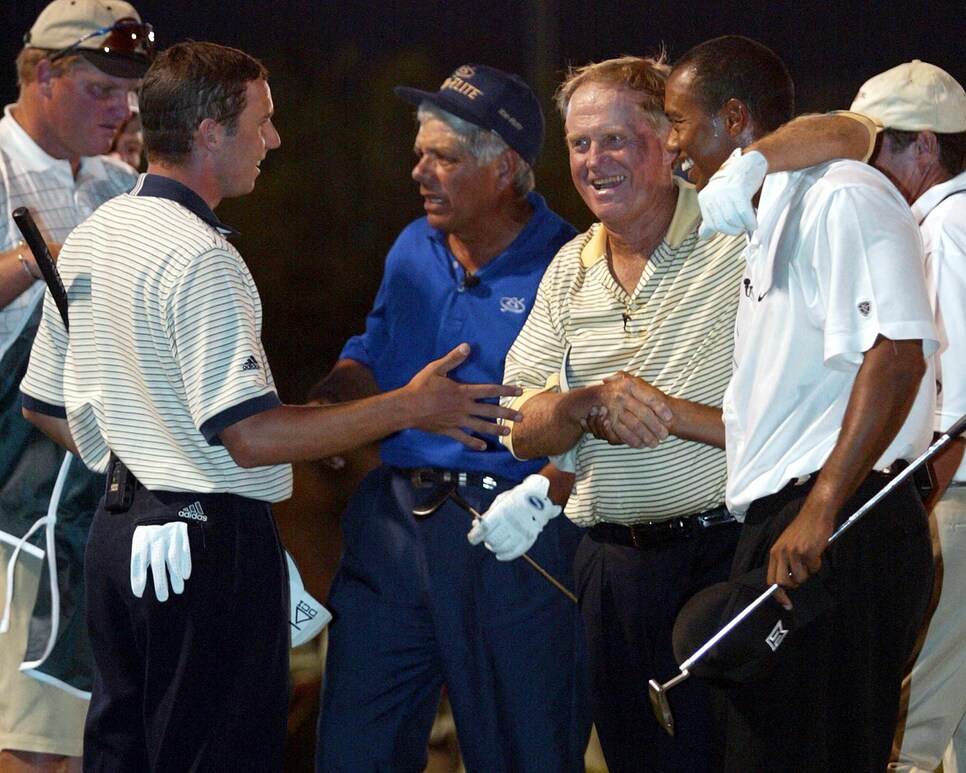 Golf legend Jack Nicklaus (2nd R front) hugs his p