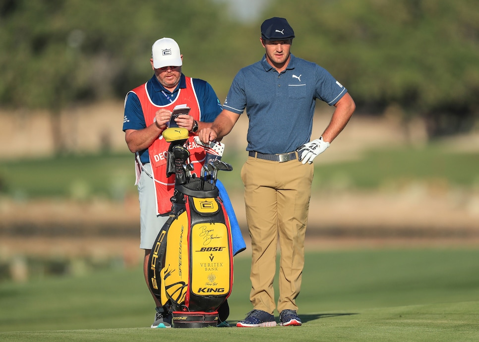 bryson-dechambeau-abu-dhabi-2020-fairway-caddie-contemplating-shot.jpg