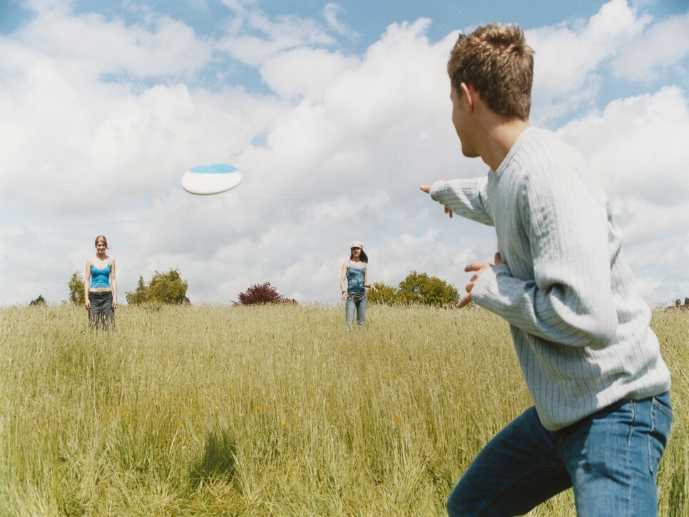 Young People Playing Frisbee