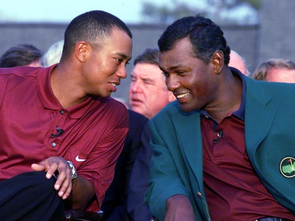 Tiger Woods (L) of the US shares a laugh with 2000