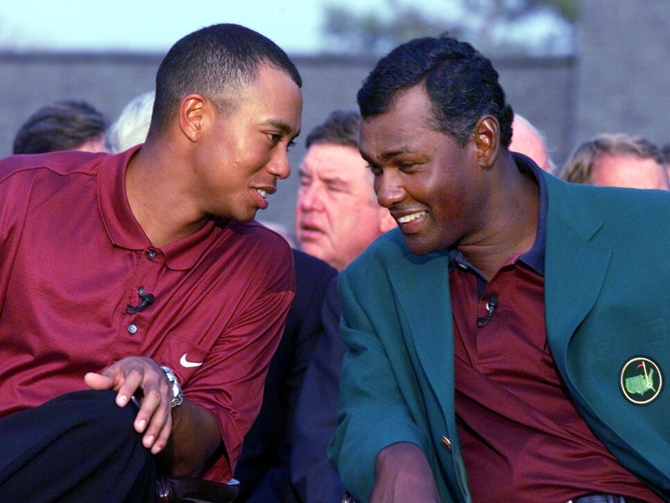 Tiger Woods (L) of the US shares a laugh with 2000