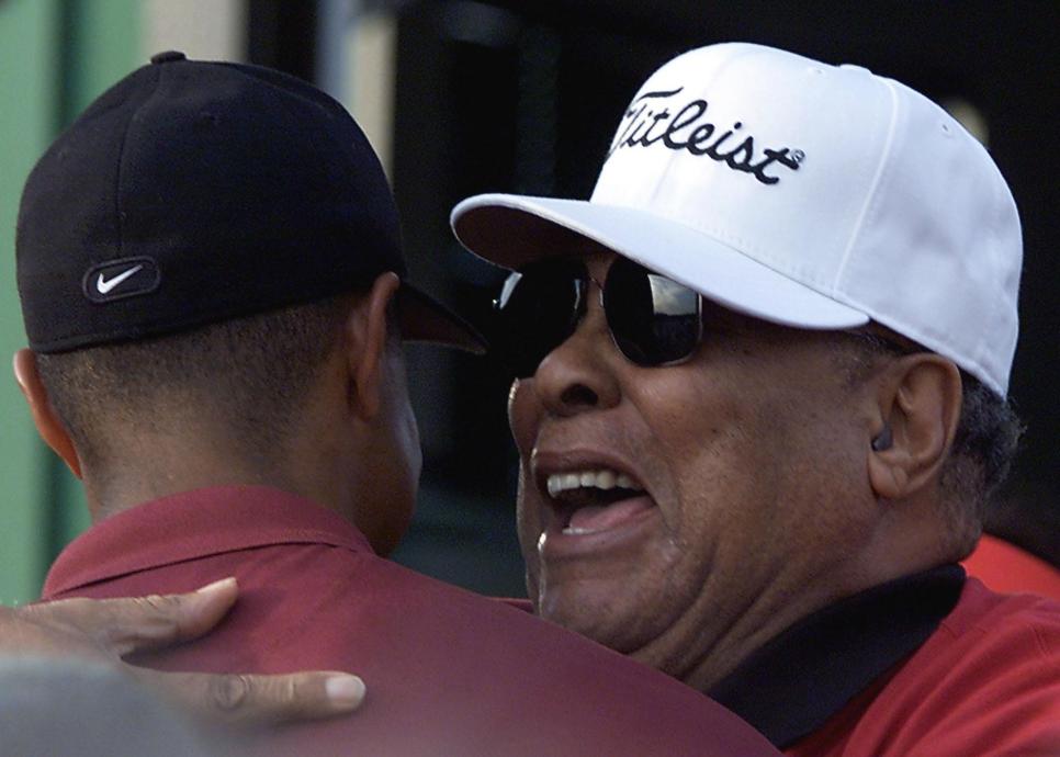 Tiger Woods of the US (L) is hugged by his father