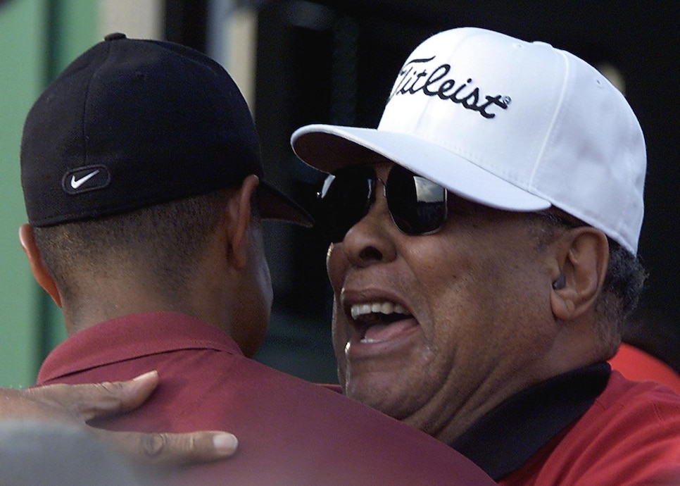 Tiger Woods of the US (L) is hugged by his father