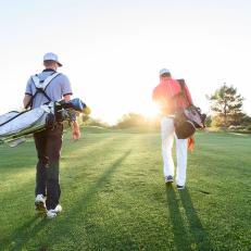 golfers-playing-near-sunset-walking-down-fairway.jpg